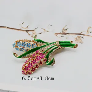 Close-up of vintage enamel flower brooch showing detailed rhinestones and dimensions.