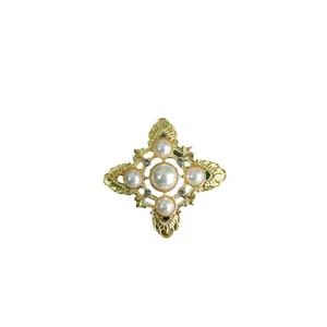 Elegant vintage Baroque style brooch featuring pearls and crystals in a gold metal finish