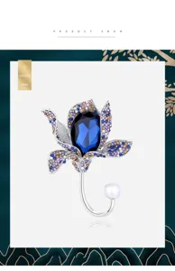 Detailed view of an elegant vintage flower brooch with blue crystal and pavé rhinestones