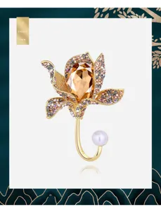 Elegant vintage floral brooch with champagne crystal petals and white pearl accent