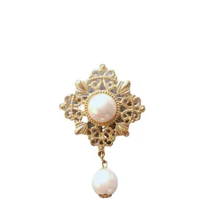 Elegant vintage baroque gold-tone brooch featuring a large pearl inlay and dangling pearl