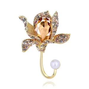 Elegant golden flower brooch with champagne faceted crystal and white pearl accent