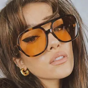 Oversized retro aviator sunglasses with tortoise frame and orange tinted lenses for women