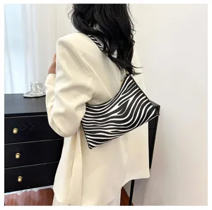 Fashionable zebra print underarm shoulder bag for women styled with a white blazer