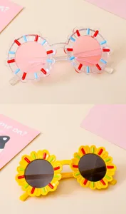Detail view of colorful sunflower-shaped sunglasses for kids in pink and yellow frames