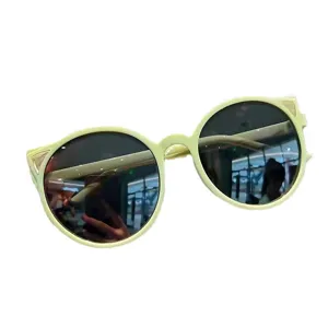 Stylish light green round UV400 protective sunglasses for kids with cat ear details