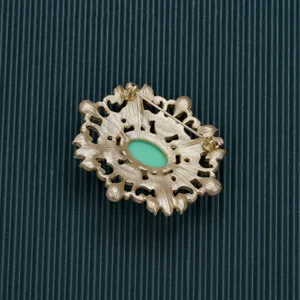 Detailed back view of vintage Baroque style gold-toned brooch showing the pin mechanism