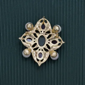 Detailed view of the back structure and pin of the vintage Baroque gold-toned brooch