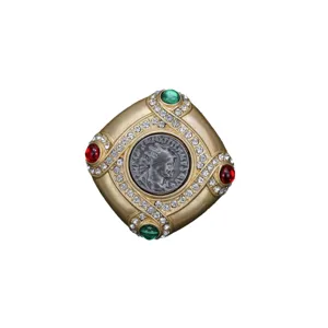 Vintage Baroque gold brooch pin with central coin relief and colorful rhinestones