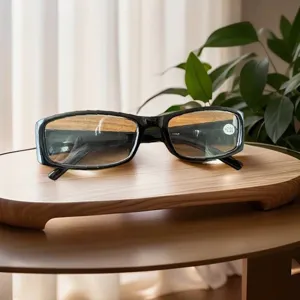 Detailed view of black square-frame reading glasses with +2.50 lens on a wooden stand.