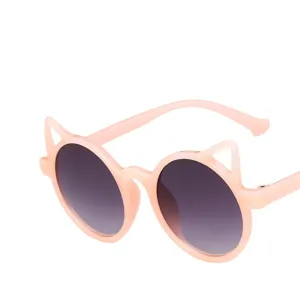 Detail view of pink cat ear sunglasses for kids with dark gradient lenses