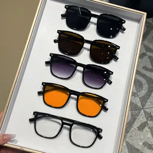 Stylish square frame sunglasses collection featuring multiple lens colors on a tray