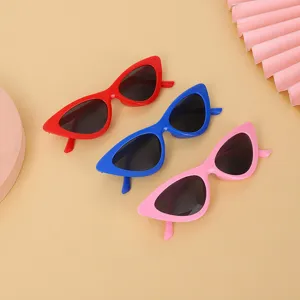 Detailed view of vintage cat-eye sunglasses in red, blue, and pink colors