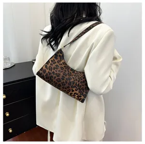Leopard print underarm bag paired with a stylish white blazer for office commute