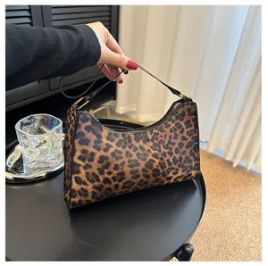 Close-up view of a trendy leopard print underarm bag with a retro shoulder strap design