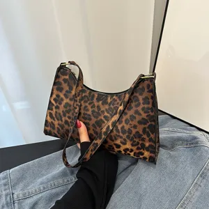 Stylish leopard print underarm bag for women featuring a retro baguette design and texture