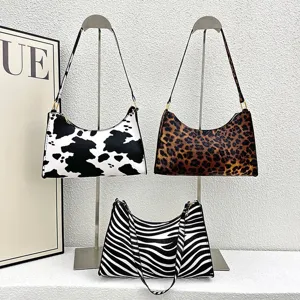 Set of retro animal print underarm bags featuring leopard, zebra, and cow patterns on stands