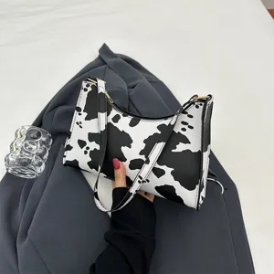 Stylish cow print underarm shoulder bag with a minimalist retro design for modern women