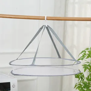 Foldable hanging drying net mesh basket for laundry and socks in a minimalist indoor setting