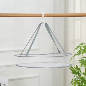Detailed view of a white collapsible mesh drying net with grey hanging straps and hook