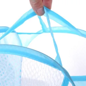 Detail view showing the durable handle and mesh texture of this blue laundry basket