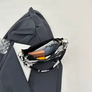 Internal view of cow print baguette bag showing capacity for phone and makeup