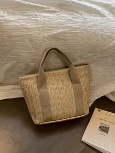 Bolso de mano de paja tejida en una escena rústica de vacaciones con tonos tierra
