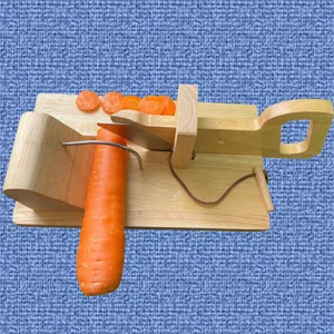 Handcrafted wooden sausage and vegetable slicer with stainless steel blade in action
