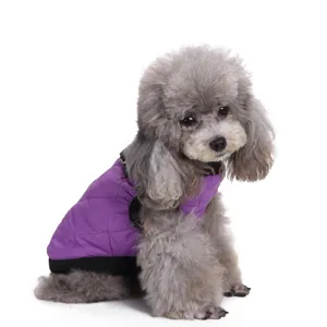 Side view of a gray poodle wearing a purple quilted winter pet jacket for cold weather