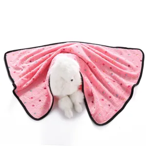 Closeup of the soft pink double-sided fleece pet blanket with colorful dots and black trim.
