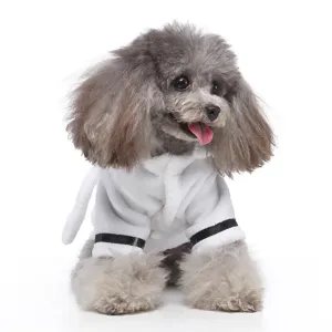Grey poodle wearing a luxury plush white pet bathrobe with black stripe detailing.