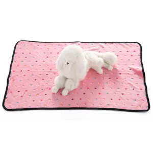 Detailed view of the pink fleece pet blanket with cute colorful prints for cozy resting.