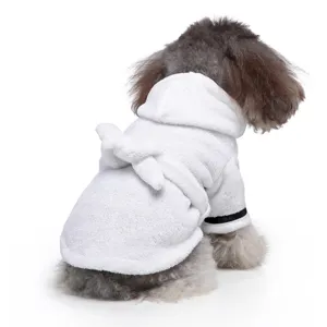 Detail view of a small dog wearing a cozy white hooded pet bathrobe with soft waist tie