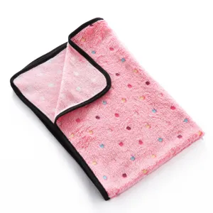 Soft pink fleece pet blanket with colorful polka dots and black binding for cozy daily use.