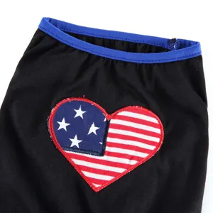 Close-up detail of pet dog clothes black fabric with blue trim and flag heart patch.