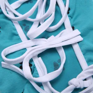 Close-up view of the pet surgical suit featuring adjustable white straps and paw prints.