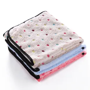 Detailed view of soft plush pet blanket folded neatly featuring colorful dots and black trim.