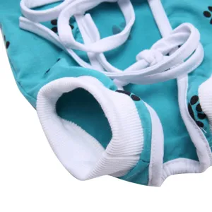 Pet dog surgery recovery suit detail showing soft teal fabric and secure cotton straps.