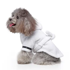 Side view of grey poodle wearing soft white hotel-style pet bathrobe with hood