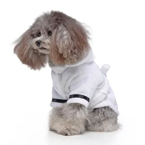 Side view of a small dog wearing a soft white plush pet bathrobe with a hood