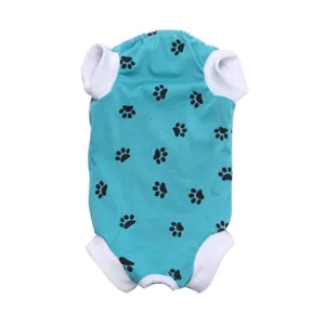 Detailed view of the teal pet recovery suit with black paw prints and white trim.