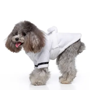 Detailed side view of a gray poodle wearing a white plush hotel-style pet bathrobe