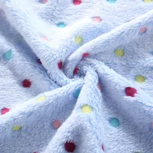 Close-up of soft blue fleece pet blanket fabric featuring colorful polka dot pattern details.