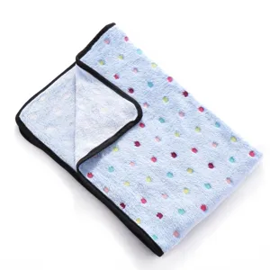 Detailed texture close-up of soft double-sided fleece pet blanket with colorful prints.