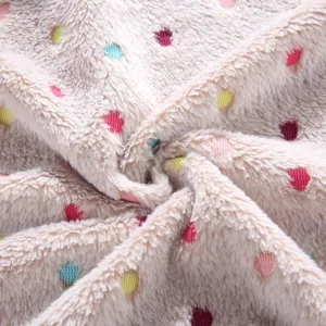 Soft double-sided fleece fabric detail with colorful polka dots for cozy pet blanket warmth.