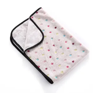 Soft double-sided fleece pet blanket detail, featuring colorful dots and neat black edging.