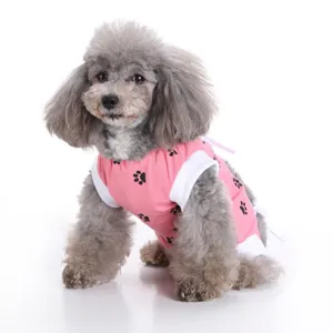 Dog recovery surgical suit detail, cute pink fabric with black paw print patterns.