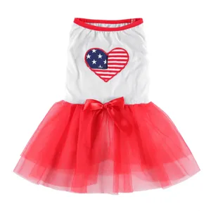 Detailed view of cute dog summer dress, red tutu skirt, American flag heart patch and bow.