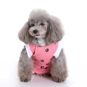 Detailed close-up of the pink pet recovery suit featuring cute black paw print patterns.