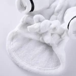 Detail view of the soft plush fabric and tie-waist of this white pet bathrobe.